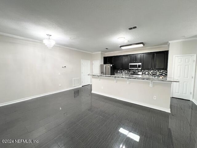 a large kitchen with stainless steel appliances a large counter top