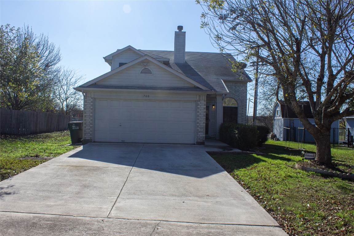 a front view of house with a garden