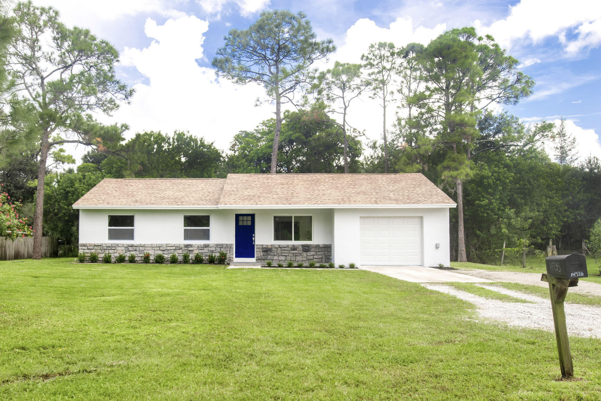 a front view of house with yard and green space