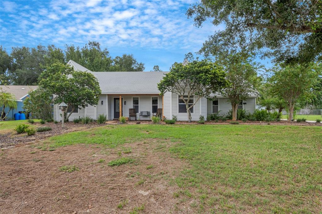 a view of a house with yard and tree s