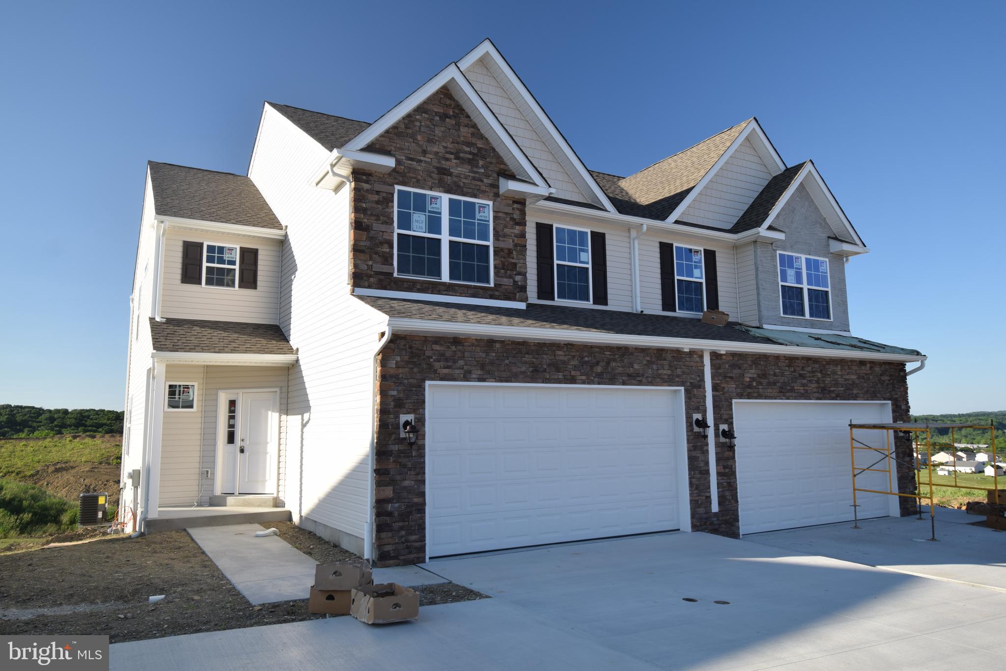 a front view of a house with a garage