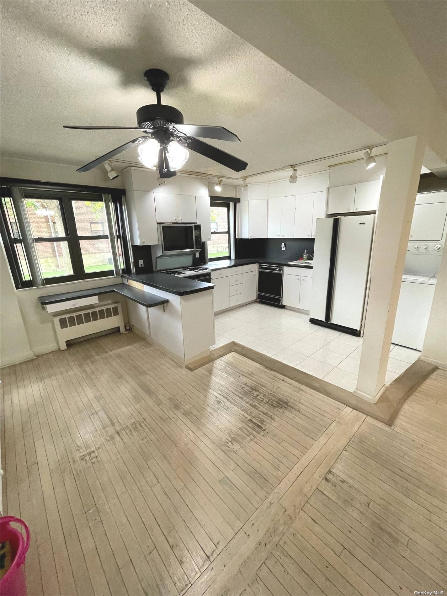 a kitchen with stainless steel appliances kitchen island granite countertop a stove a sink and a refrigerator