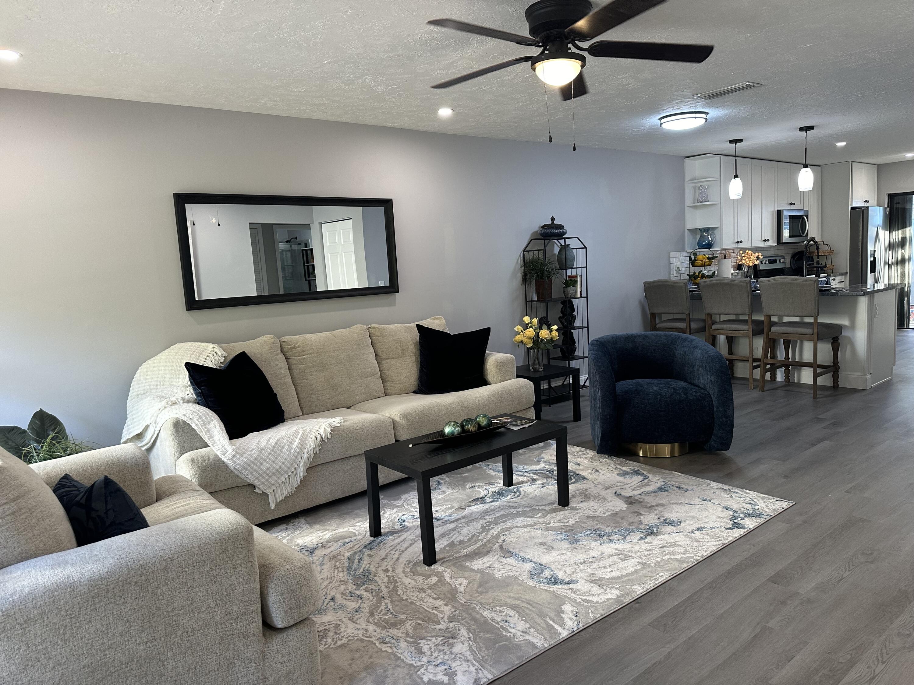 a living room with furniture and a wooden floor