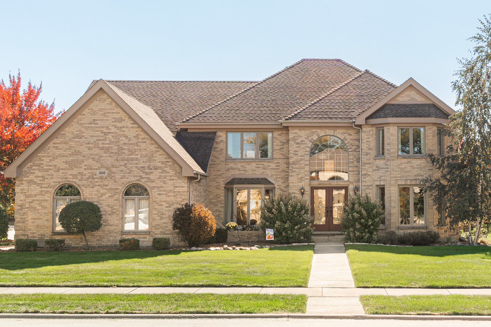 a front view of a house with a yard