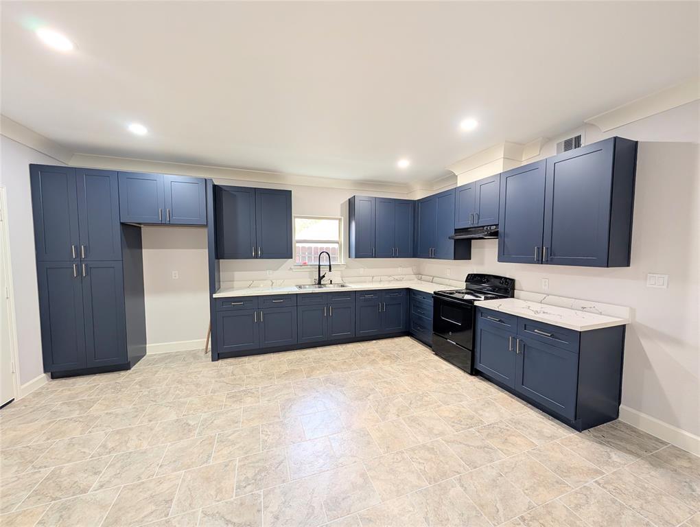 a large kitchen with kitchen island granite countertop wooden cabinets and stainless steel appliances