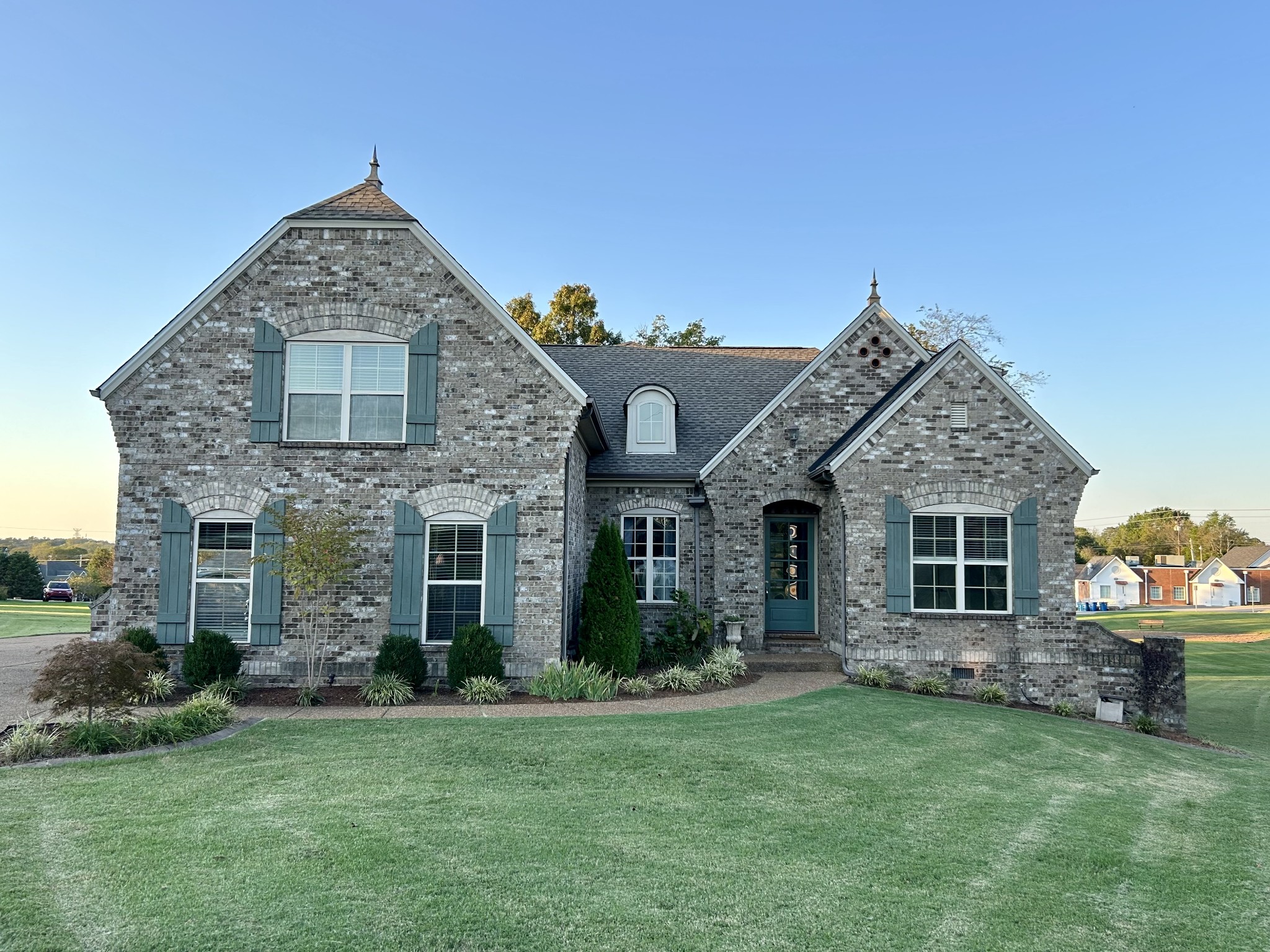 a front view of a house with a garden