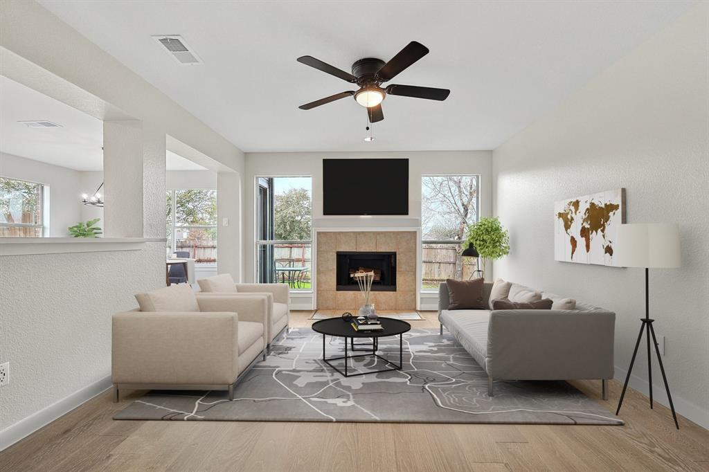 a living room with furniture a fireplace and a flat screen tv