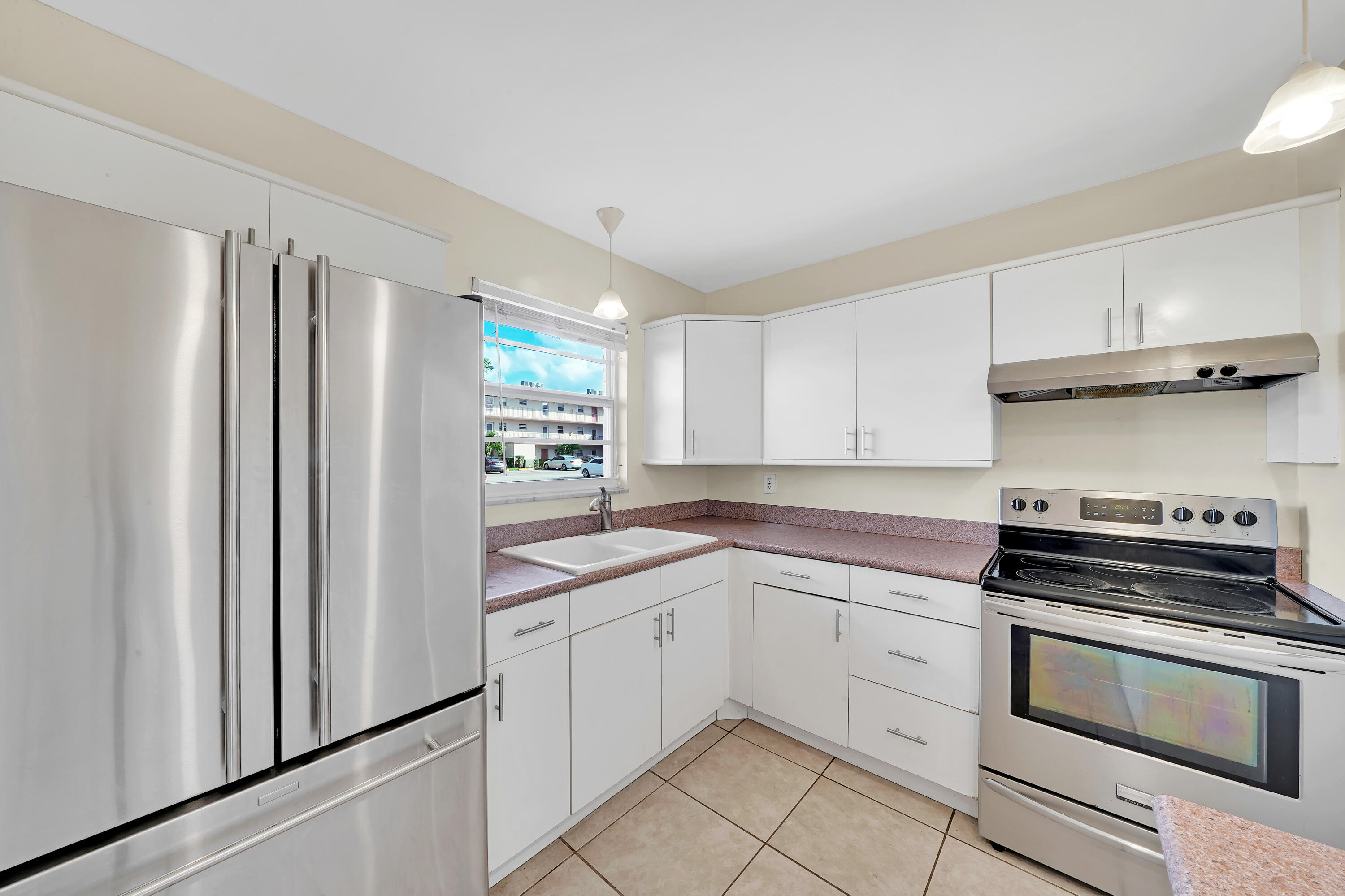 a kitchen with white cabinets and white appliances