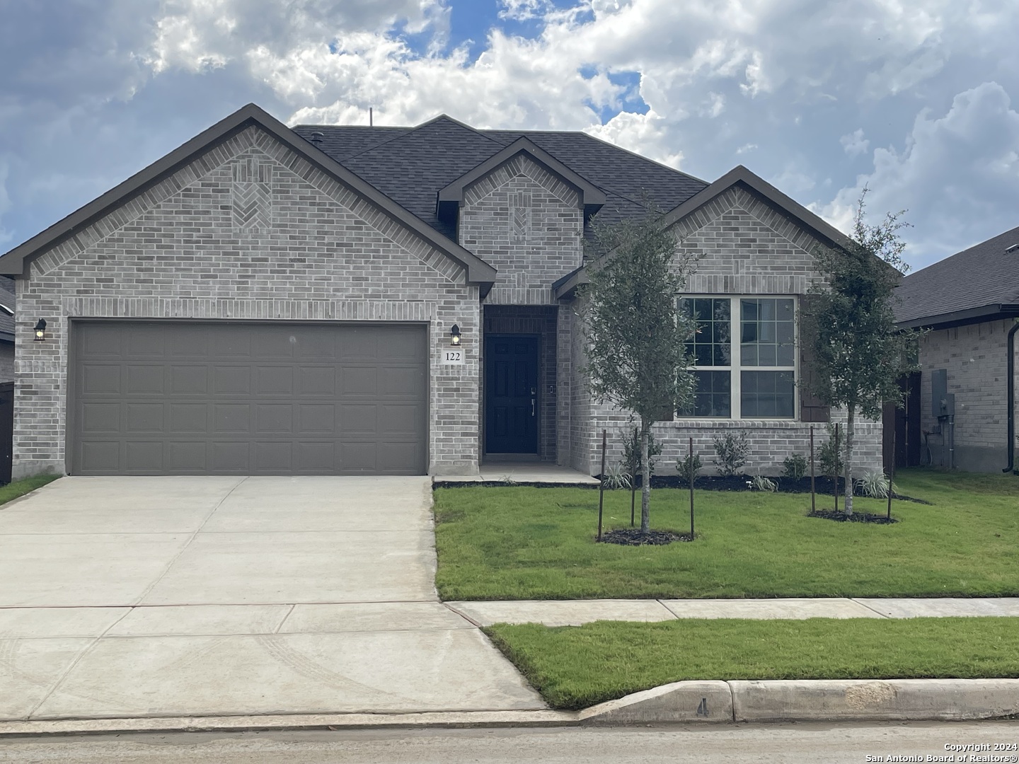 a front view of a house with a yard