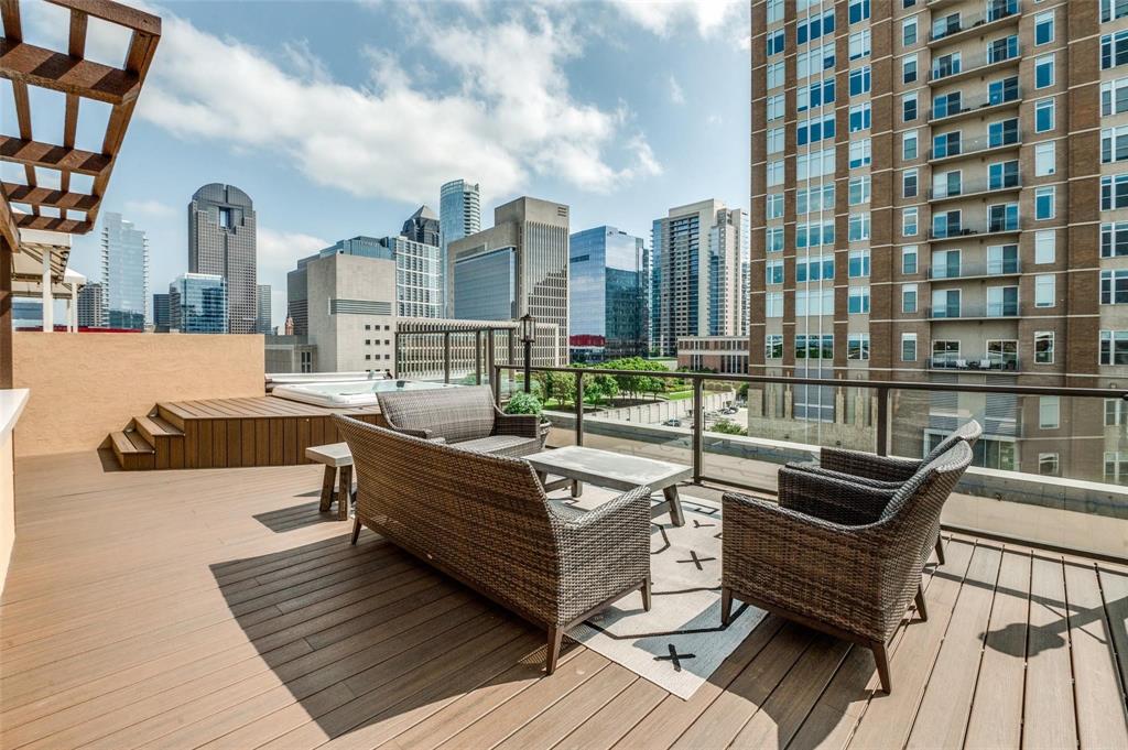 a view of a roof deck with couches and wooden floor