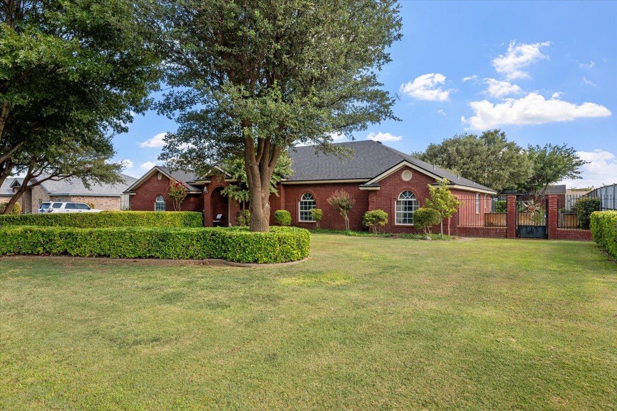 a front view of house with yard and green space