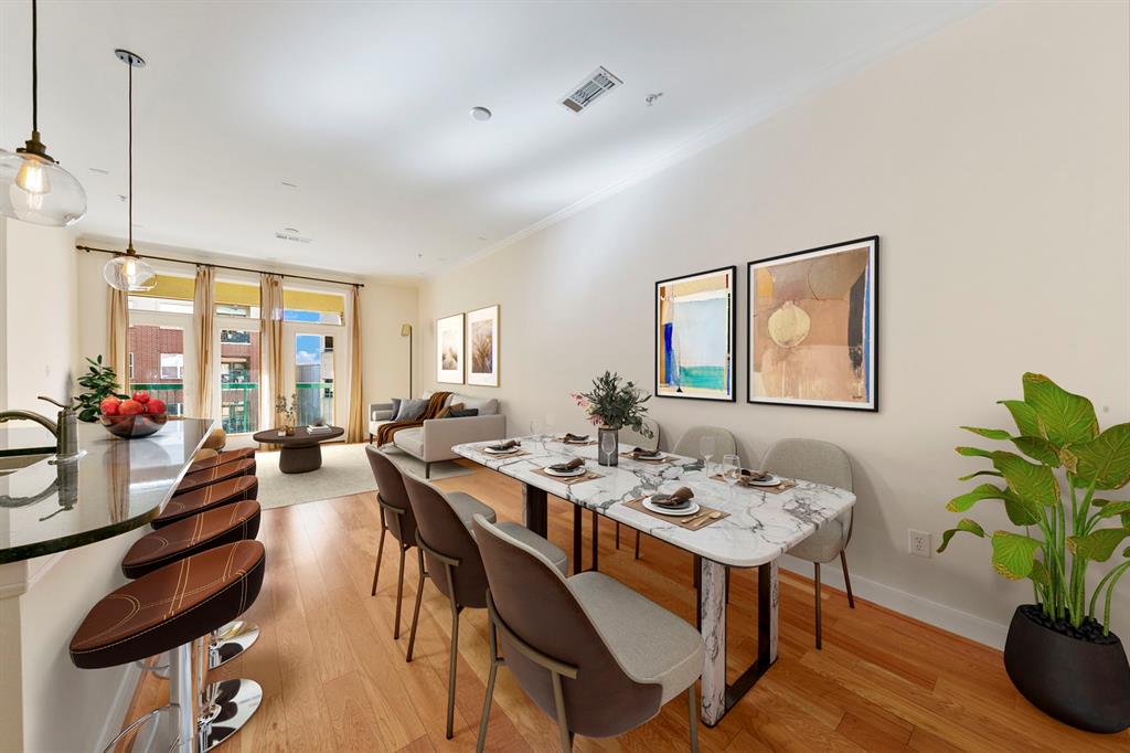 a view of a dining room with furniture window and wooden floor