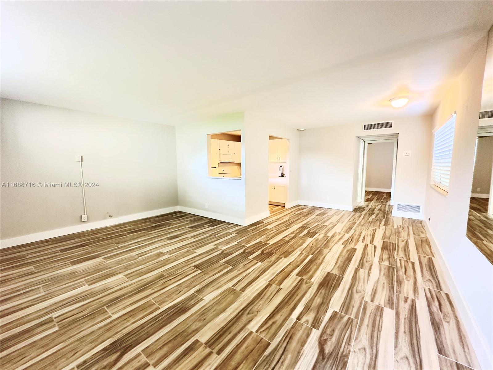 a view of a room with wooden floor and bedroom