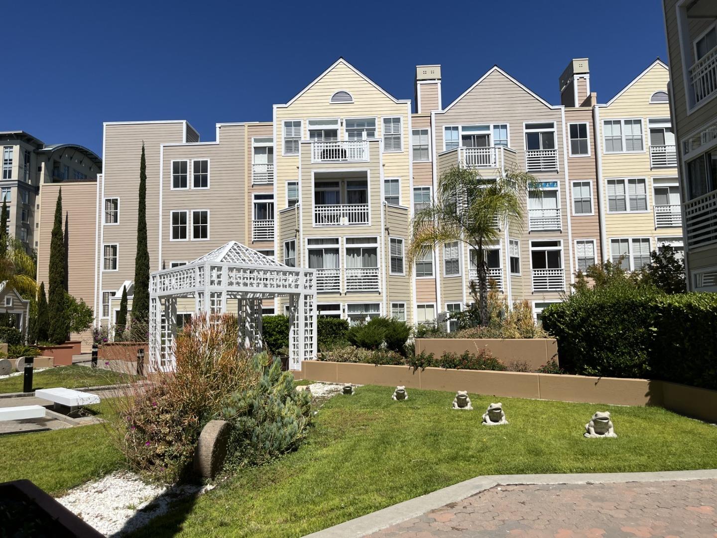 a front view of a residential apartment building with a yard