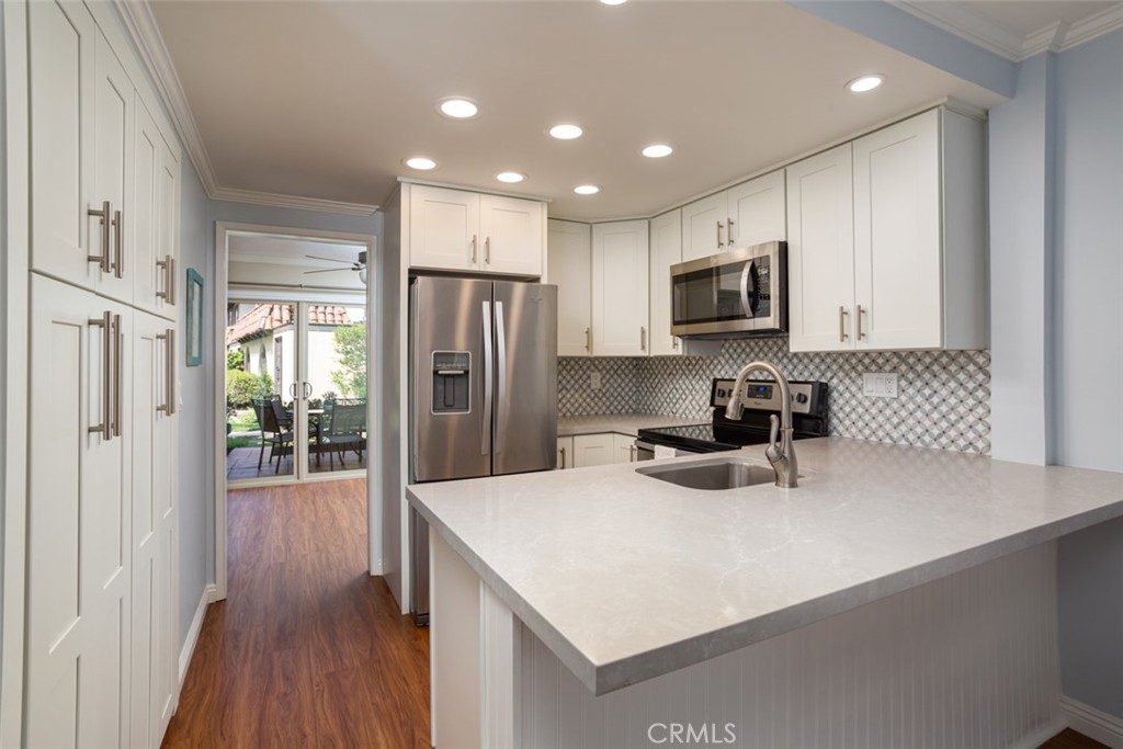 a kitchen with refrigerator and a sink