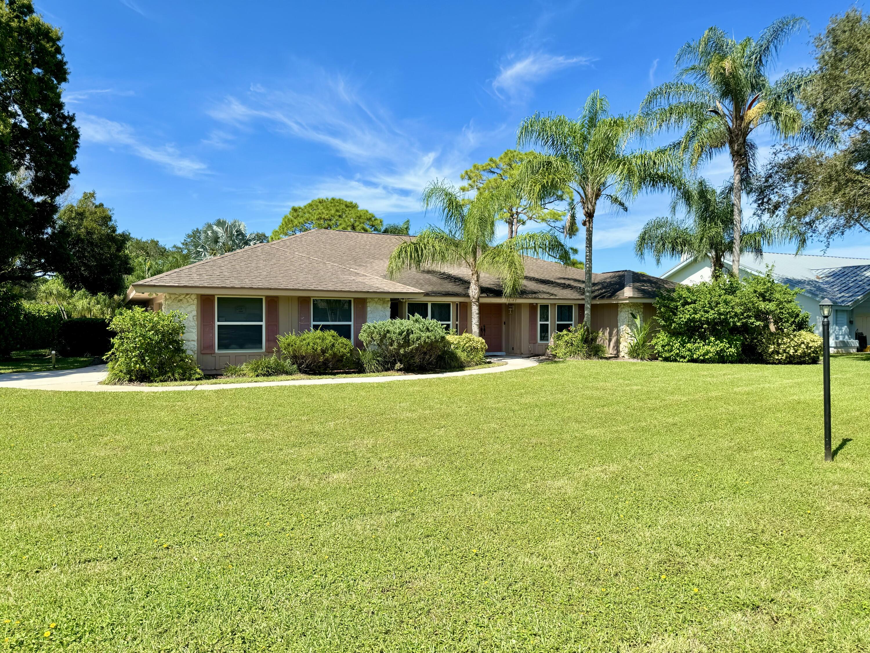 a front view of house with yard and trees