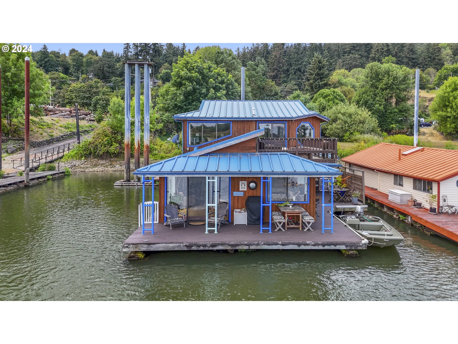 a aerial view of a house with swimming pool and a yard