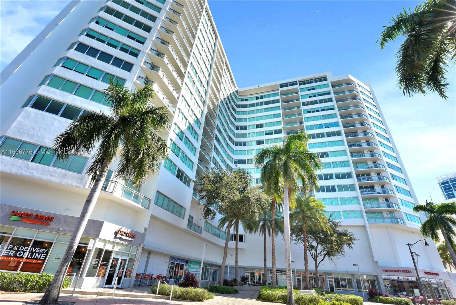 a view of a palm tree in front of a building