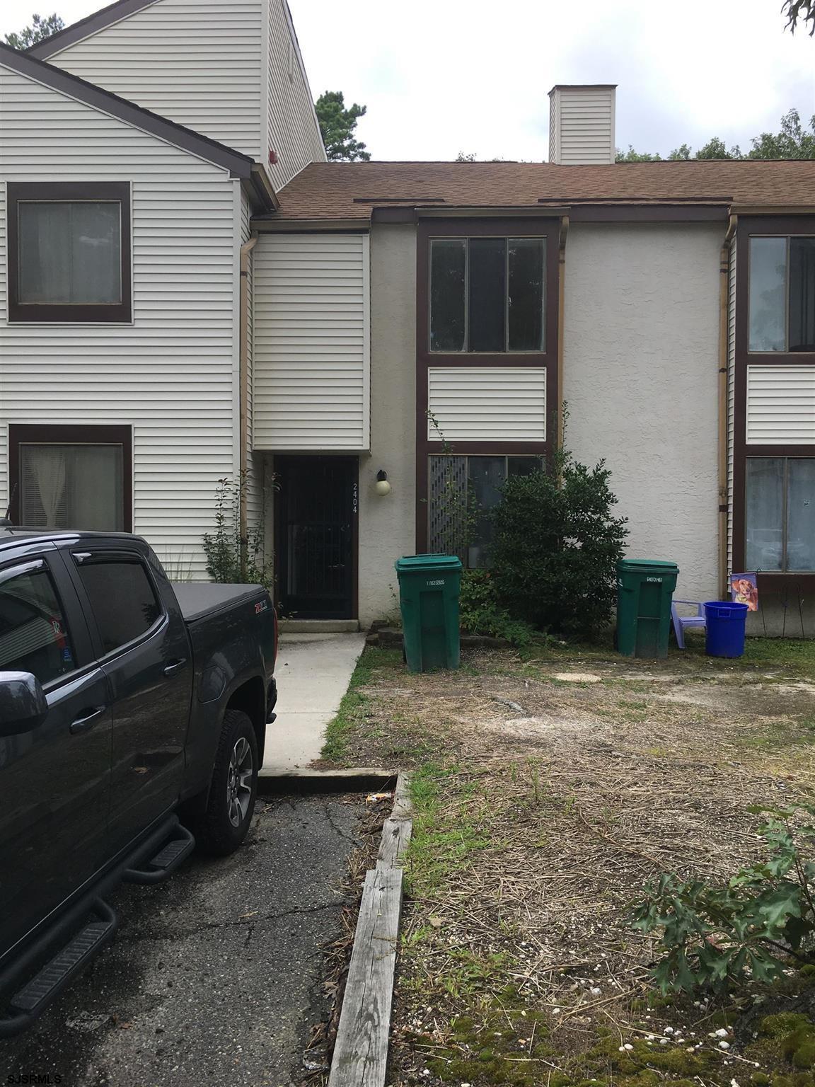 a view of a house with backyard and furniture