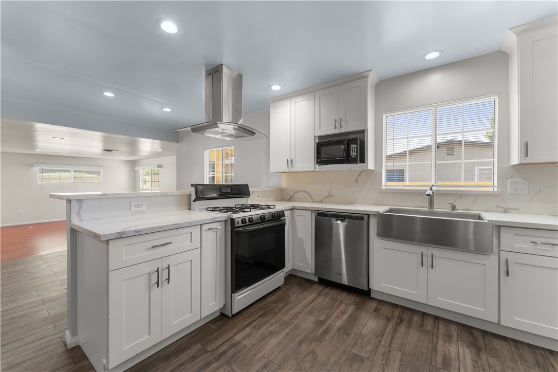 a kitchen with stainless steel appliances granite countertop a stove and a sink