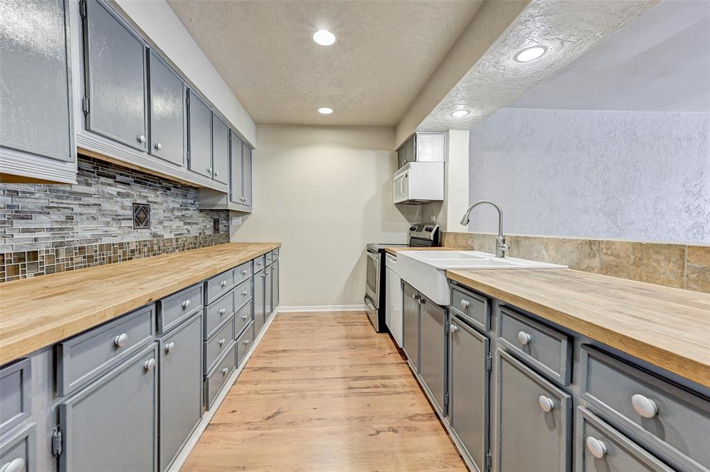 a kitchen with kitchen island granite countertop a sink and cabinets