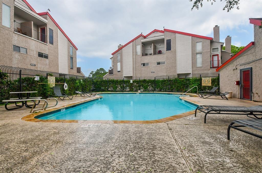 a view of a swimming pool with lounge chair