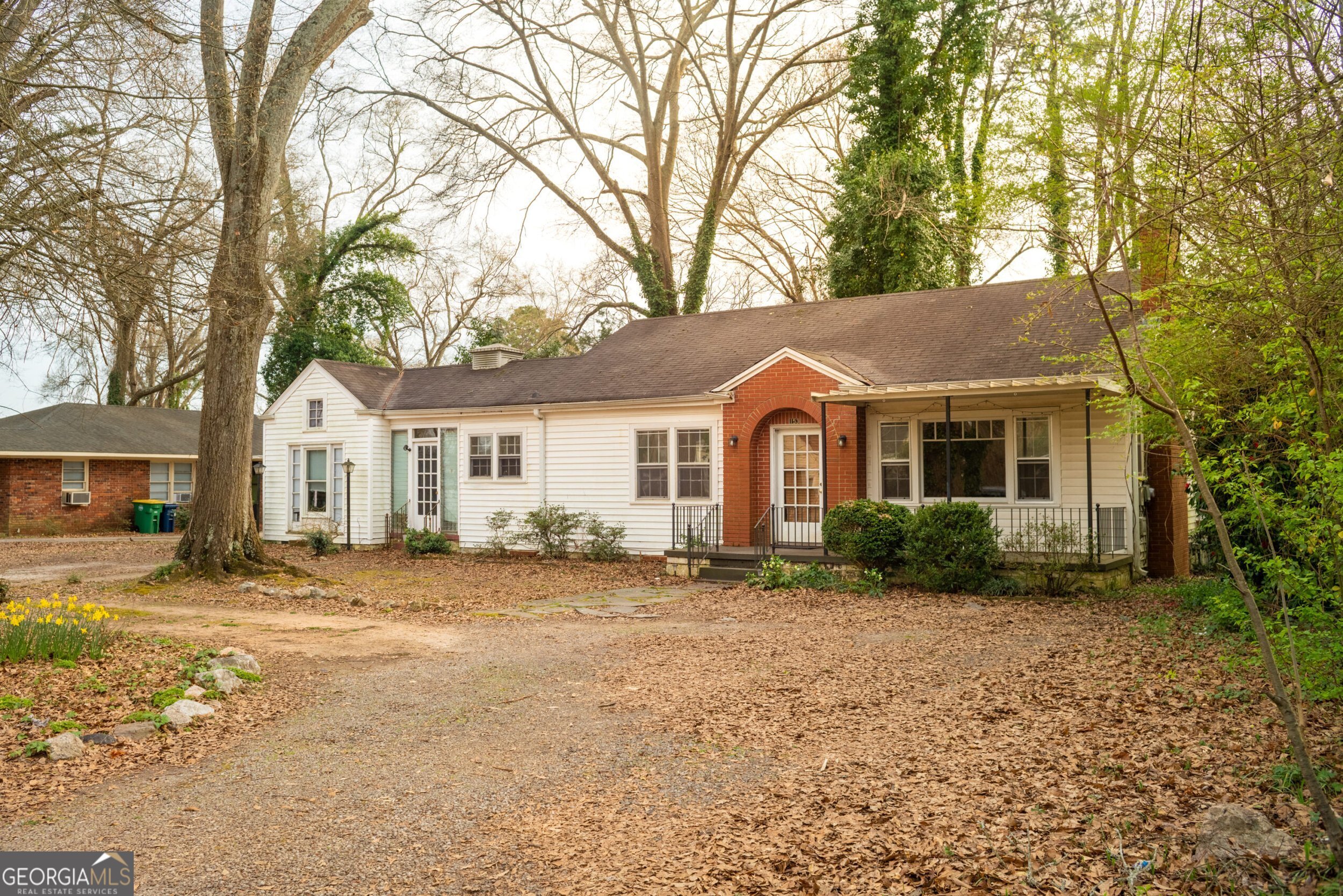 a front view of a house with a garden