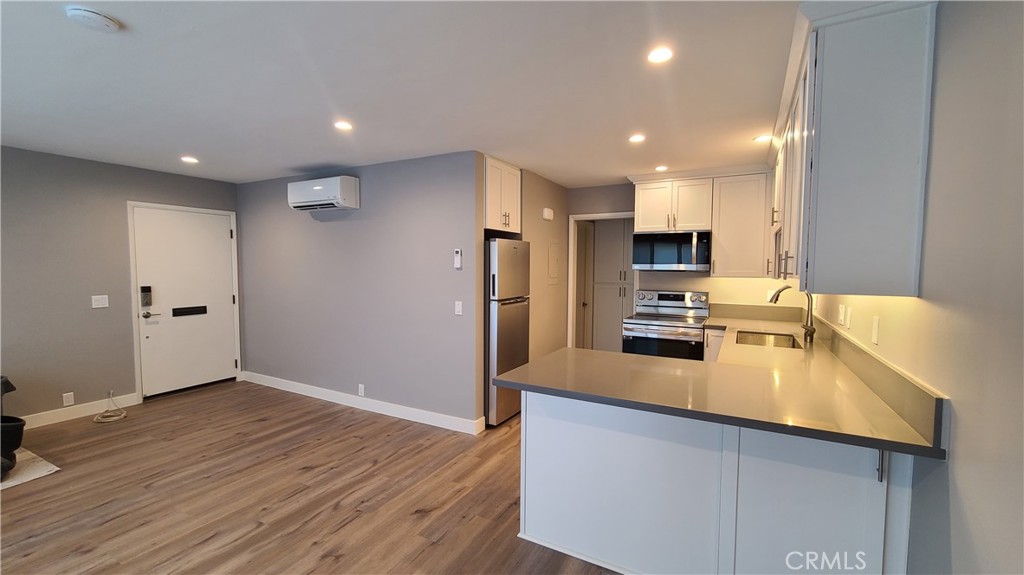 a kitchen with a refrigerator a sink and cabinets