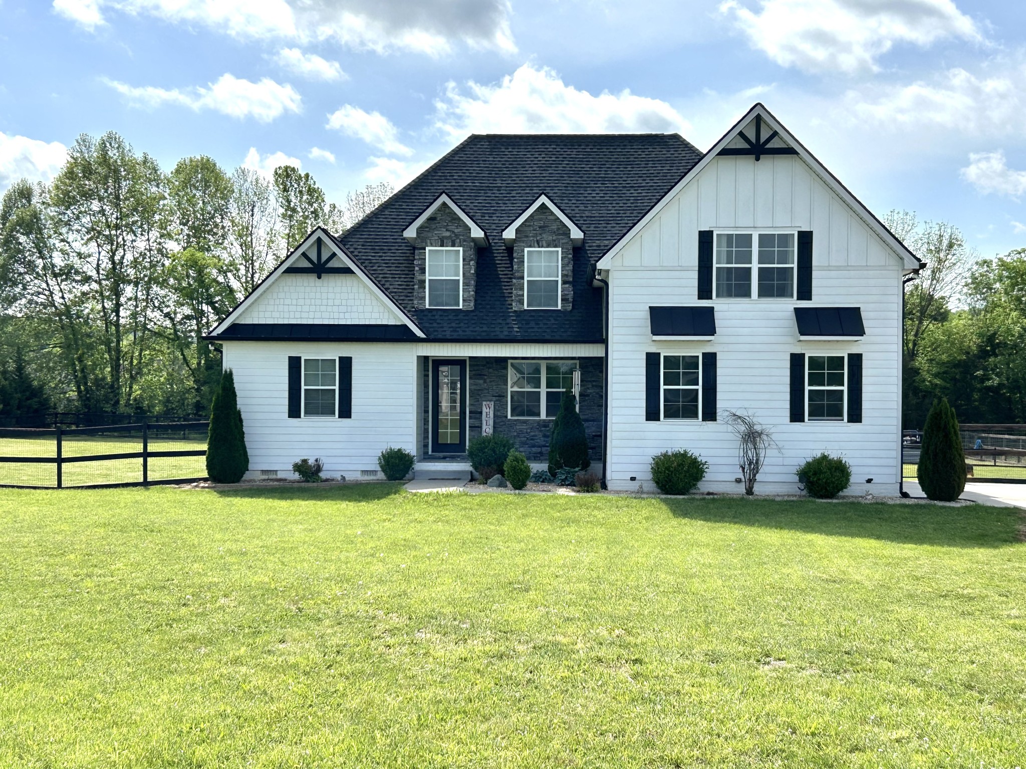 a front view of a house with a yard