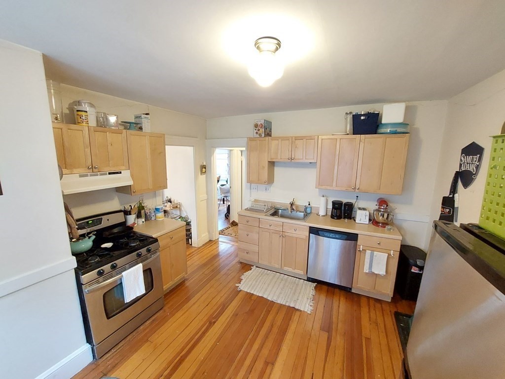 a kitchen with stainless steel appliances a stove a sink and a refrigerator