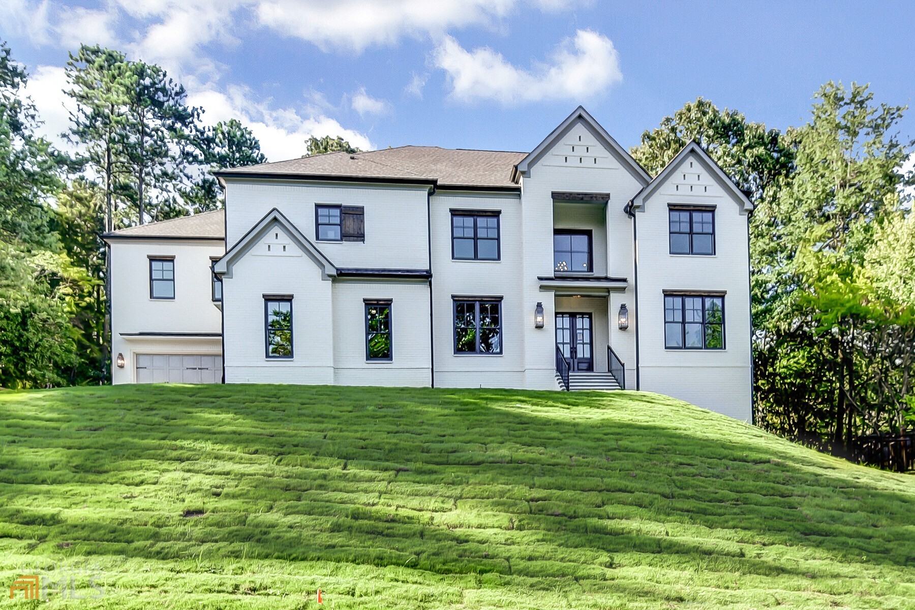 a front view of a house with a garden