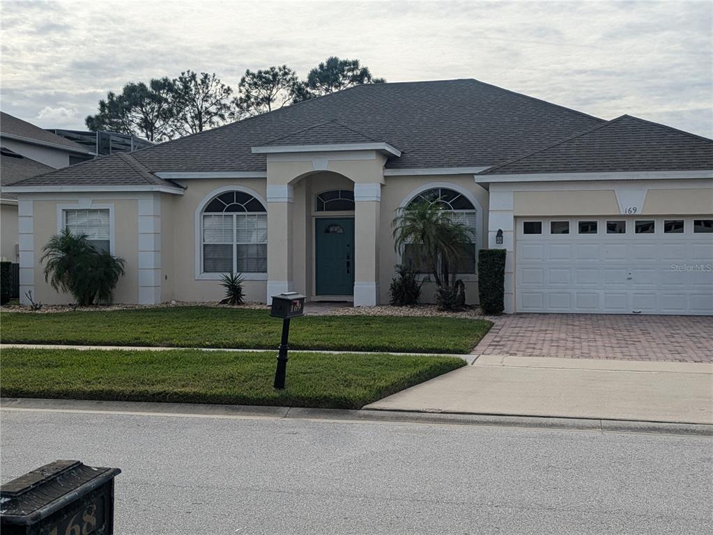 a front view of a house with a garden