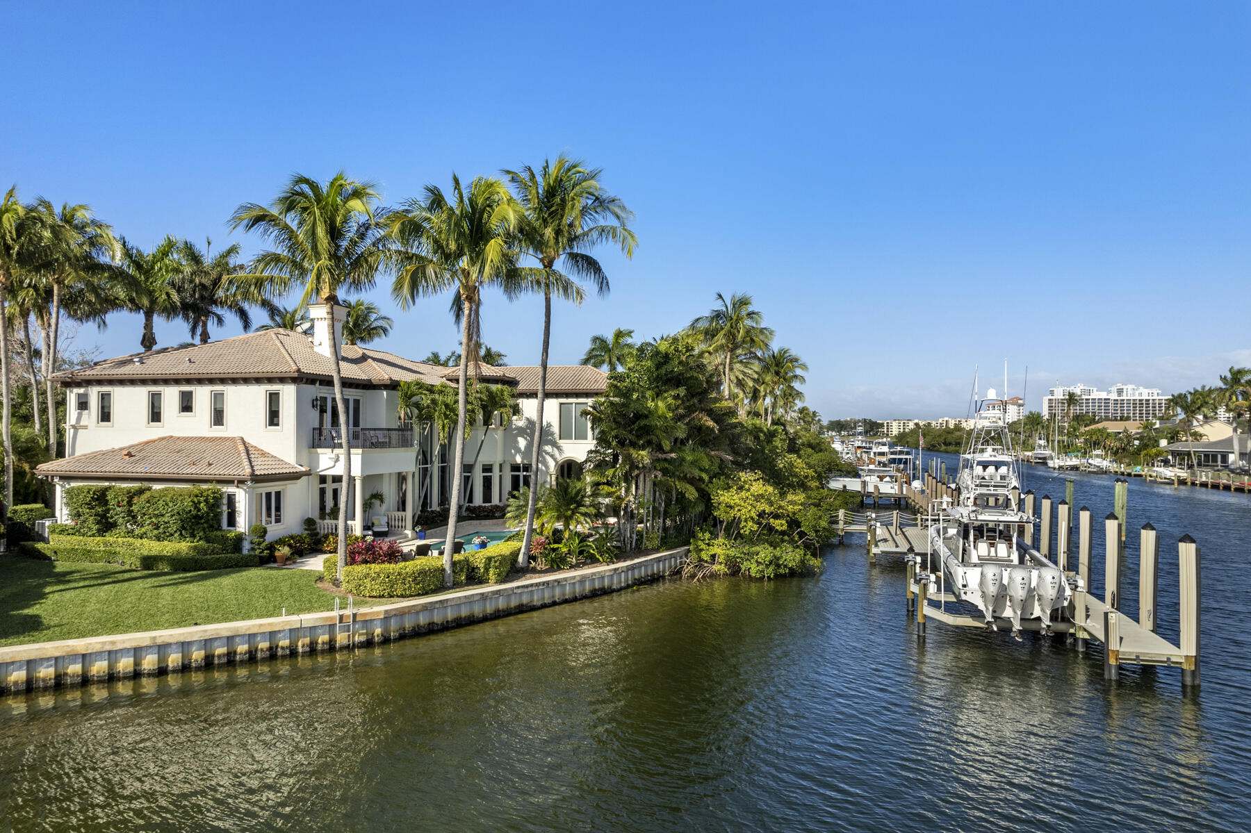 a view of residential houses with swimming pool and lake view