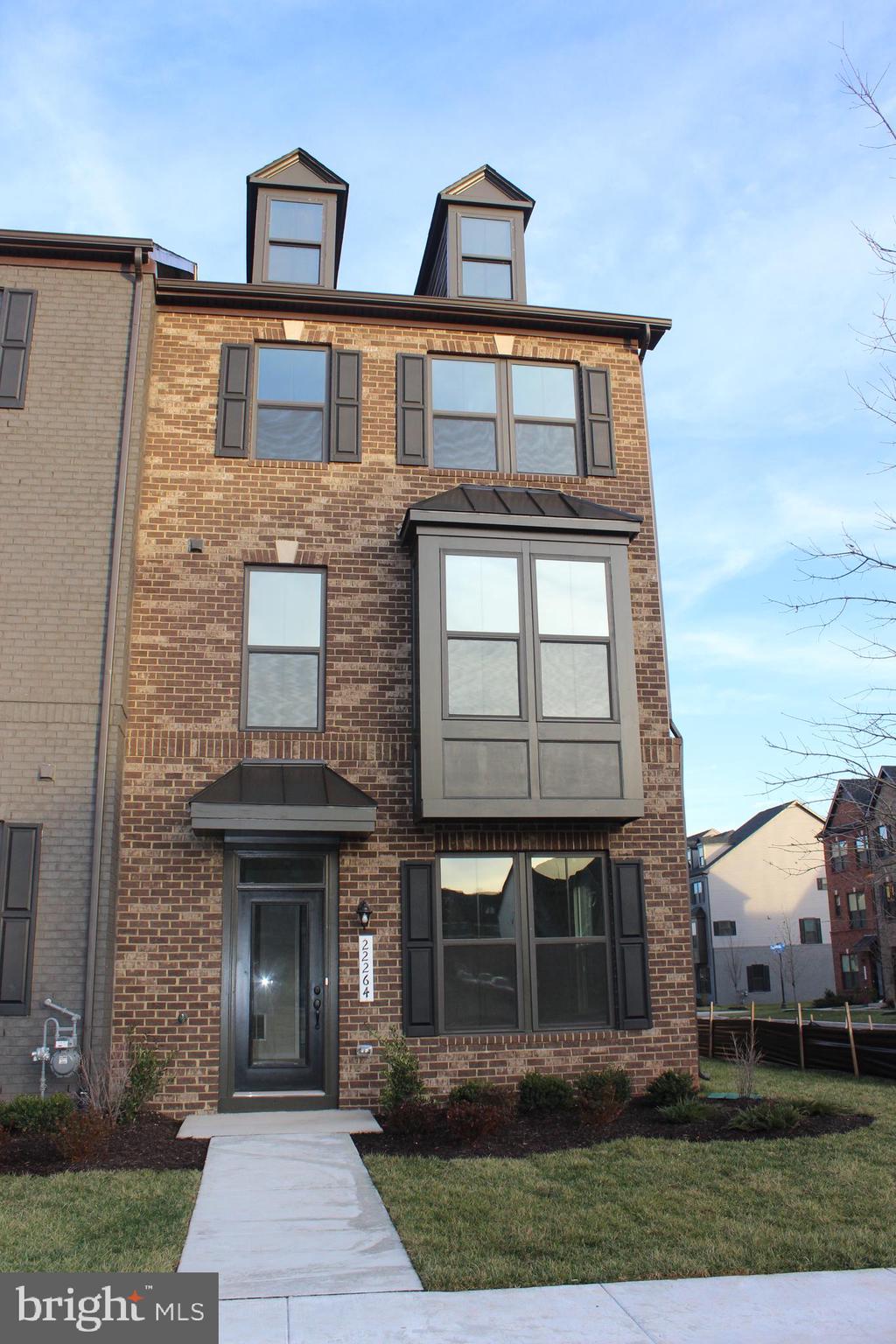 a front view of a house with yard