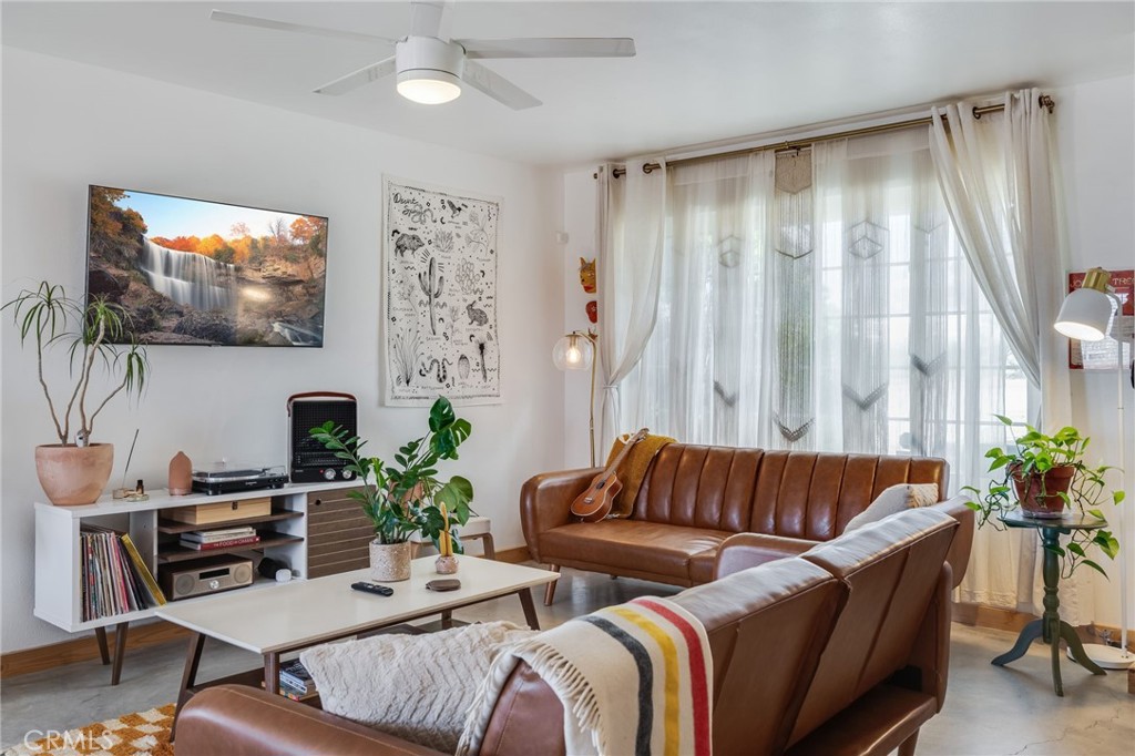 a living room with furniture a rug and a flat screen tv