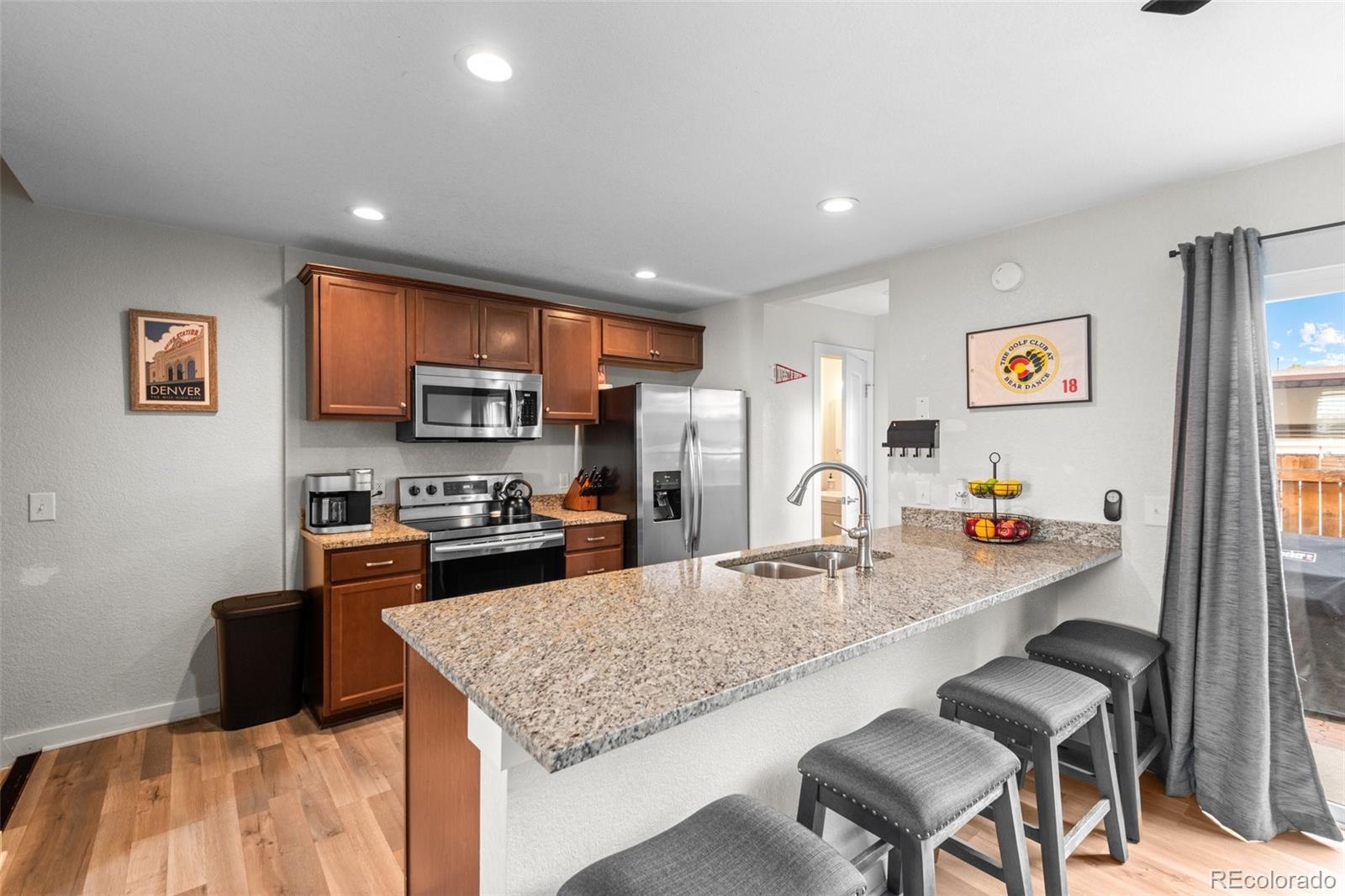 a kitchen with granite countertop lots of counter top space furniture and stainless steel appliances