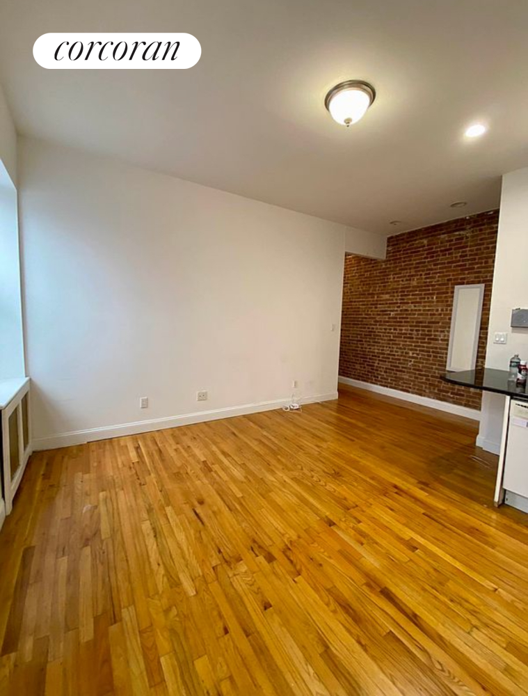 a view of an empty room and wooden floor