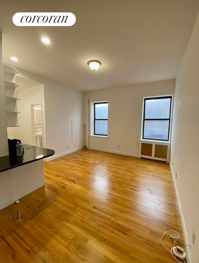 a view of a kitchen with wooden floor and a sink