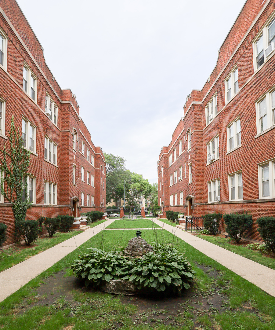 a view of a building with a yard