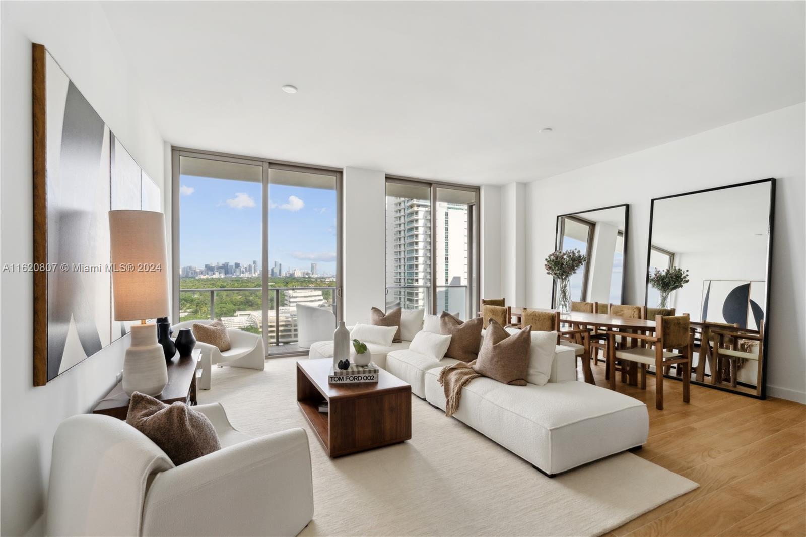 a living room with furniture and large windows