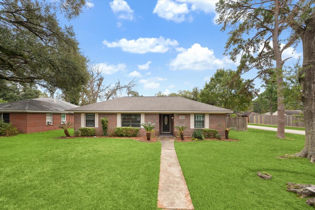 Traditional ranch style corner home, landscaped to perfection