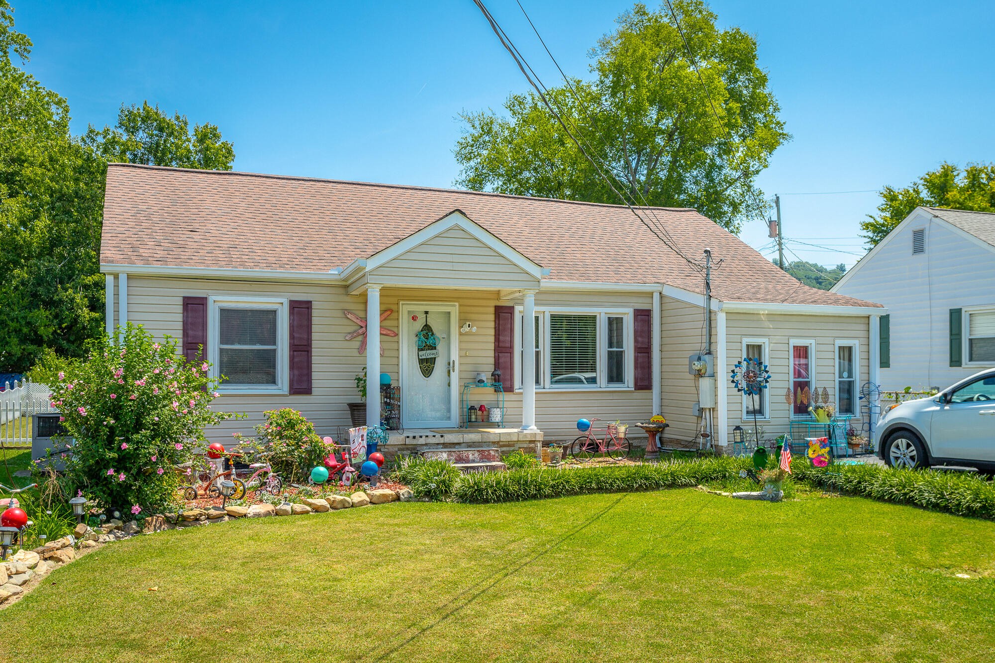 a front view of house with yard and green space