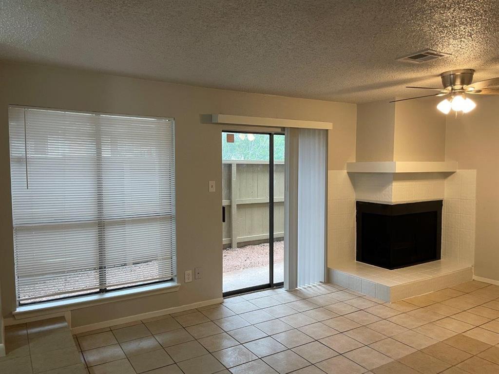 a view of an empty room with a fireplace