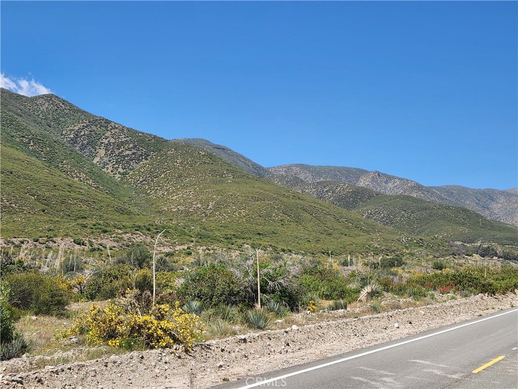 a view of a mountain with a mountain in the background