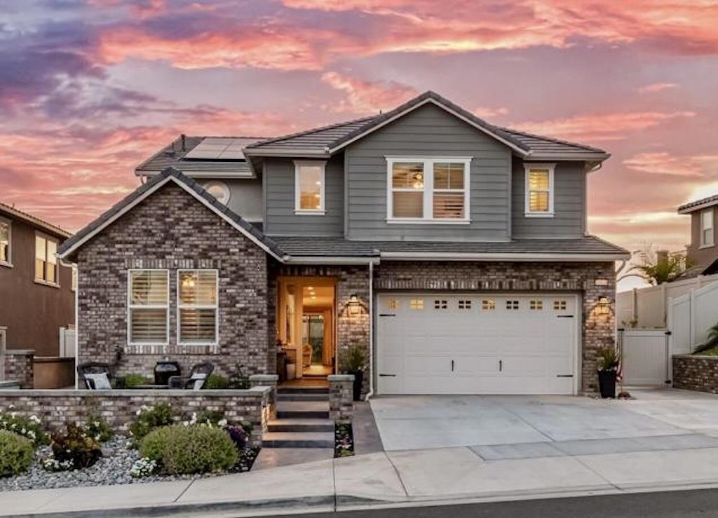 a front view of a house with a garage