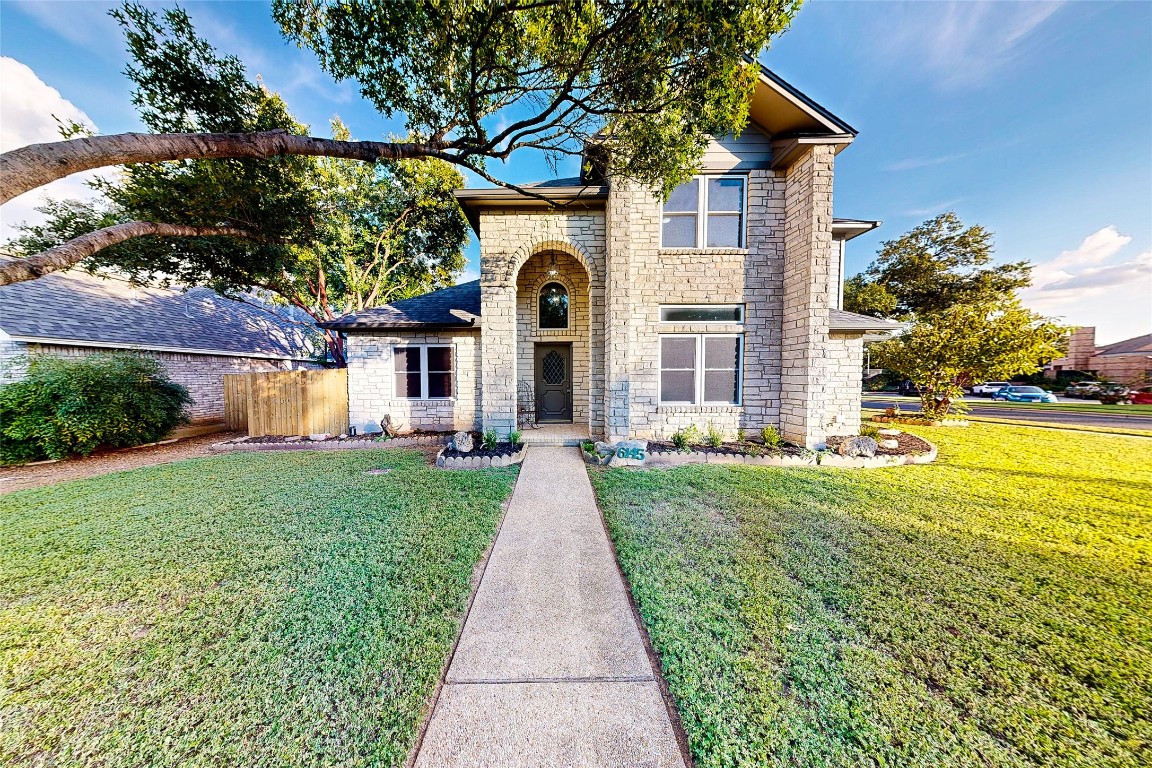 a front view of a house with garden