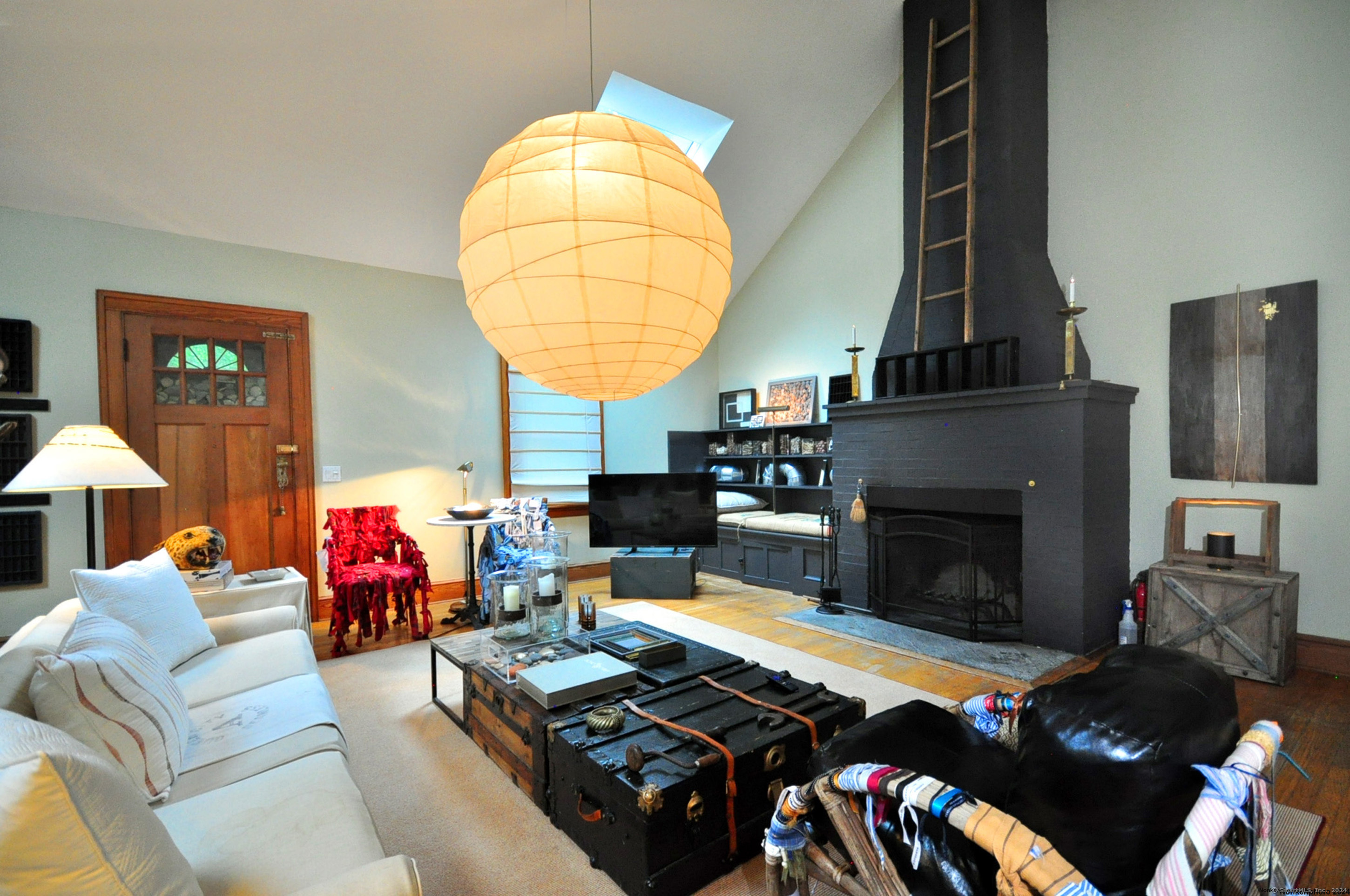 a living room with furniture fireplace and a table