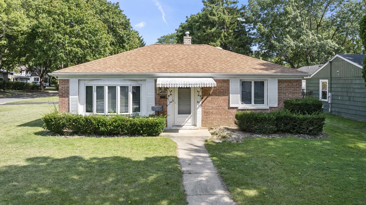 a front view of house with yard and green space