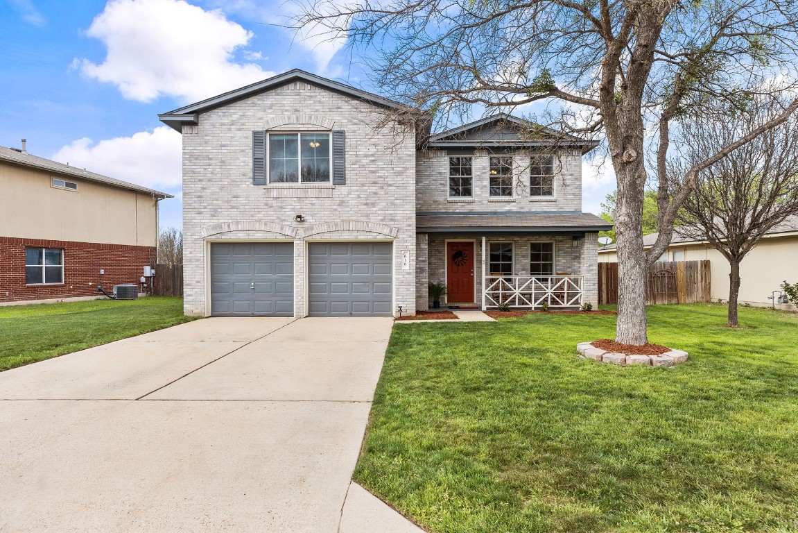 a front view of a house with a yard and garage