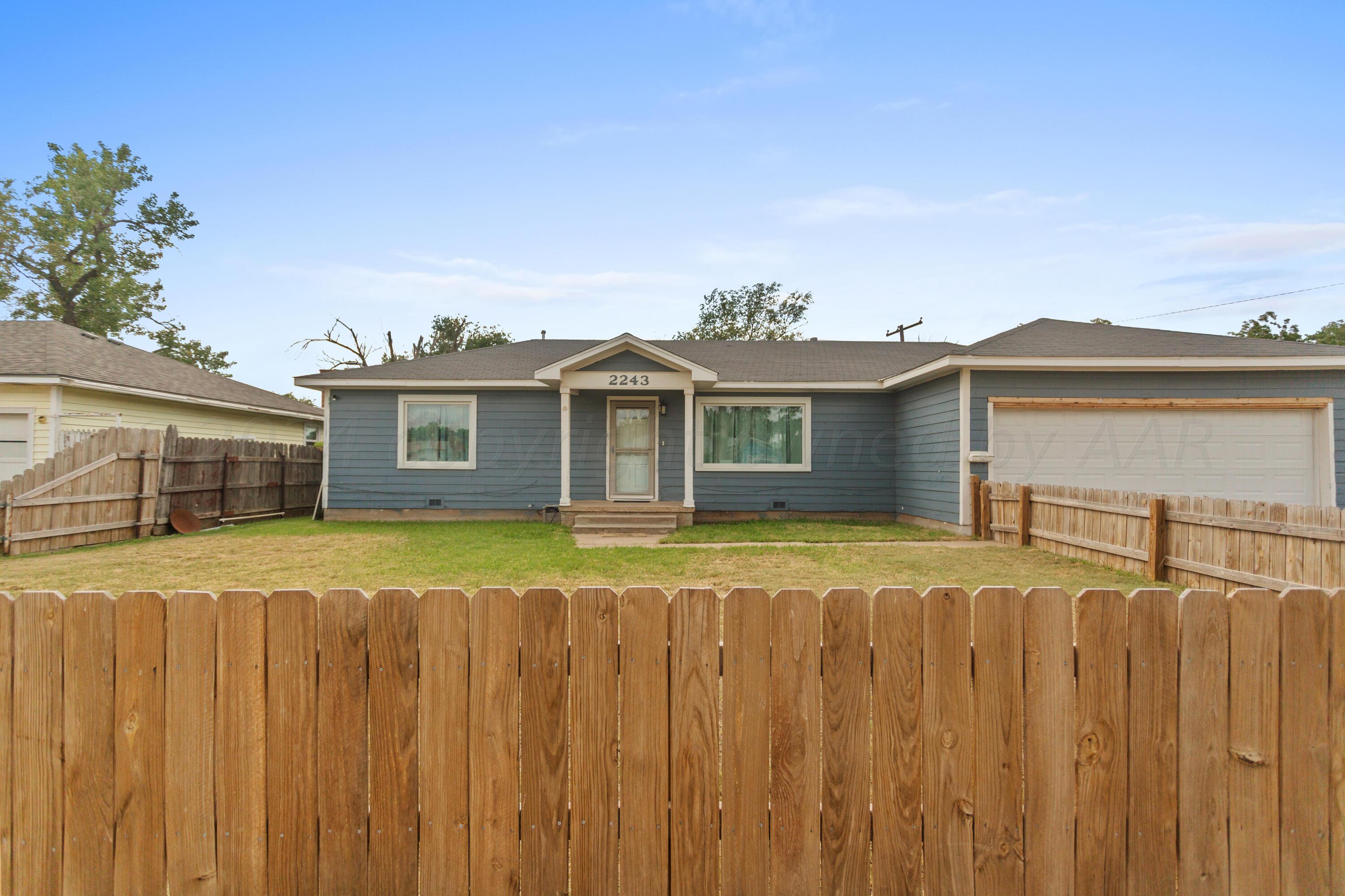 a view of a house with a backyard